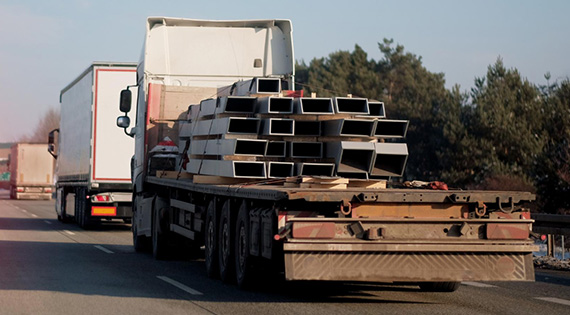 Image from behind flat deck trucks